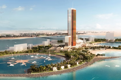 Aerial view of the upcoming Wynn Al Marjan Island Resort in Ras Al Khaimah, featuring a tall tower surrounded by beaches, villas, and a marina.